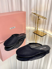 MIUMIU 26S FLAT MULES IN BLACK FABRIC AND LEATHER 