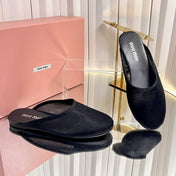 MIUMIU 26S FLAT MULES IN BLACK FABRIC AND LEATHER 