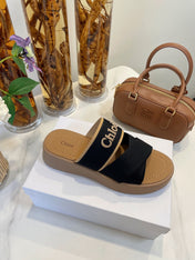 CHLOÉ WOODY WEDGE SANDALS IN BLACK CANVAS WITH CIDER BROWN RUBBER SOLE