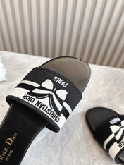 DIOR FLAT SLIDES 25S IN BLACK CALFSKIN AND FABRIC BRAND NAME EMBROIDERY