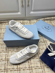 PRADA 26S LOW TOP SNEAKERS IN WHITE NYLON AND SUEDE