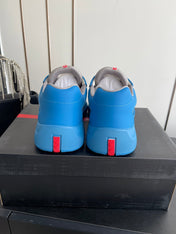 PRADA 26S AMERICA CUP SNEAKERS IN AZURE BLUE SOFT RUBBER AND BIKE FABRIC