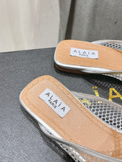 ALAIA FLAT MULES IN SILVER MESH FISHNET