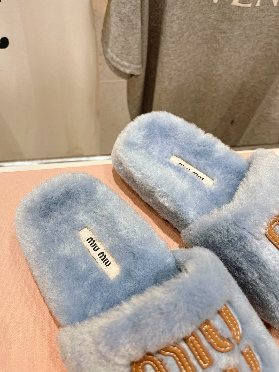 MIUMIU 26S FLAT SLIDES IN PASTEL BLUE SHEARLING