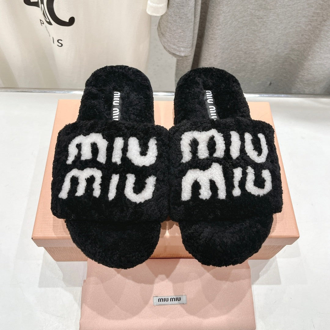 MIUMIU 26S SANDALS IN BLACK SHEARLING WITH LOGO LETTERING