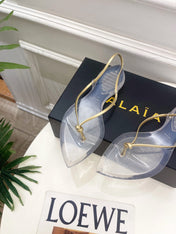 ALAIA 26S POINTED-TOE THONG SANDALS IN GOLD AND TRANSPARENT PVC
